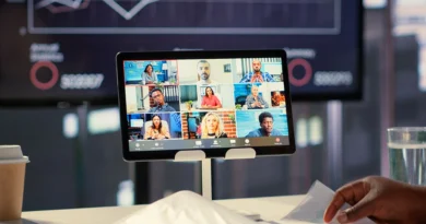 Professional presenter running a live webinar on laptop with multiple participant thumbnails visible on screen