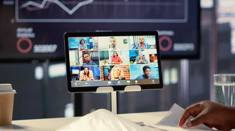 Professional presenter running a live webinar on laptop with multiple participant thumbnails visible on screen