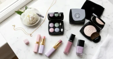Delices Pastel De Chanel makeup flat lay with eyeshadow palette, illuminating powder, and lip products on white marble