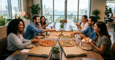 Office team sharing pizza delivery around a conference table for a workplace celebration in Miami Beach