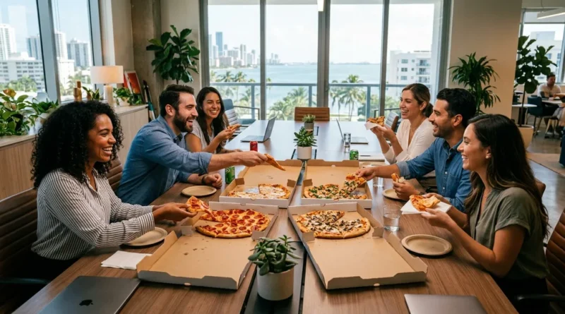 Office team sharing pizza delivery around a conference table for a workplace celebration in Miami Beach