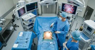 Surgeon performing laparoscopic hernia repair surgery with minimally invasive instruments